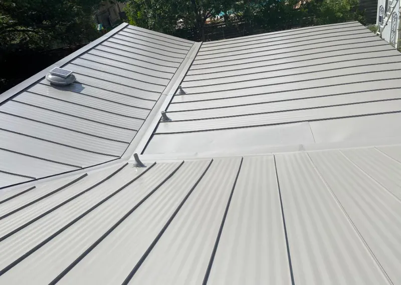 Solar attic fan installed on a metal roof for Roof Ventilation in Cliffside Park